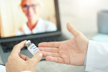 Male doctor discussing coronavirus vaccine with colleague virtually