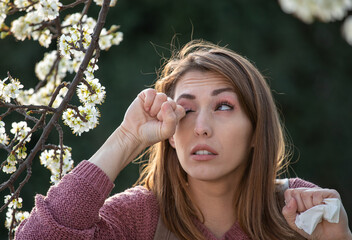 GIrl rubbing eyes because of pollen allergy in spring