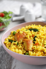 Delicious rice pilaf with meat in bowl, closeup