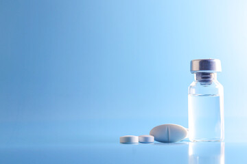 Doctor holding vial with vaccine against Covid-19 on light background, closeup. Coronavirus Vaccine / Corona virus Vaccine concept with syringe. Vaccine Concept of fight against coronavirus.
