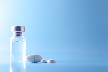 Doctor holding vial with vaccine against Covid-19 on light background, closeup. Coronavirus Vaccine / Corona virus Vaccine concept with syringe. Vaccine Concept of fight against coronavirus.
