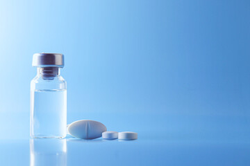 Doctor holding vial with vaccine against Covid-19 on light background, closeup. Coronavirus Vaccine / Corona virus Vaccine concept with syringe. Vaccine Concept of fight against coronavirus.
