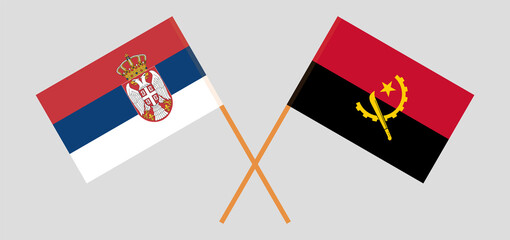 Crossed flags of Serbia and Angola. Official colors. Correct proportion