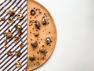 Cracked walnuts on a wooden board and white copy space background.