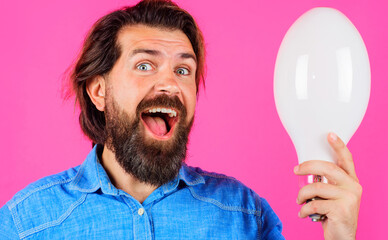 Happy man with lamp. Smiling Bearded man with bulb. Good idea. Birth of ideas.