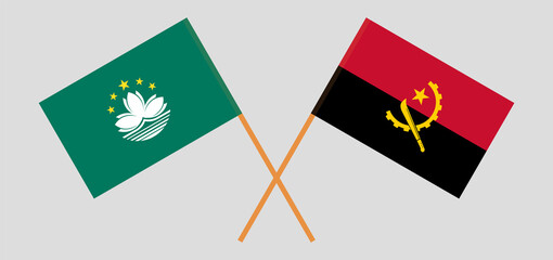 Crossed flags of Macau and Angola. Official colors. Correct proportion