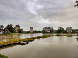 Kaiping diaolou and villages. Сoncrete watchtowers. Houses and flooded rice fields. Cloudy weather. China. Asia	