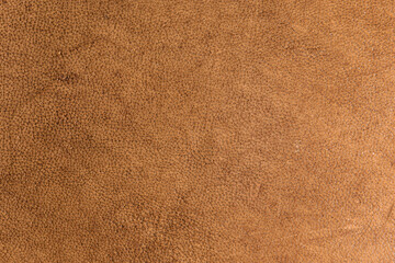 leather grunge background: an old piece of tough camel skin, with scuffs, spots, scars