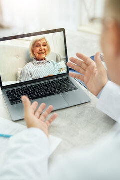 Cheerful Old Woman Having Online Consultation With Doctor