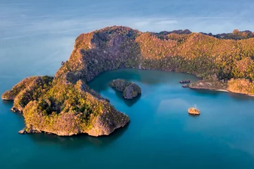 Foto op Canvas Langkawi Malaysia aerial ocean cove during the morning golden hours. Soft blue ocean waters and several islands protected by the forested peninsula © KAPhotography