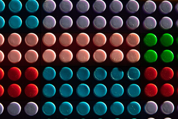 childish game background: darkened plane of plastic multi-colored bricks, blur, selective focus
