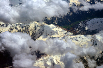 Overflight over the snow-capped.Alps with clouds in the sky