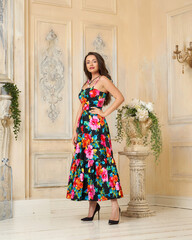 Young beautiful pretty woman wearing colorful dress with floral print full length portrait in...
