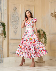 Pretty elegant female model wearing pink colorful dress with
