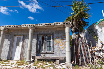 Small house that appears to be abandoned, close to the beach in a small fishing village.