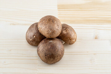 mushroom caps champignons brown stacked on light beige