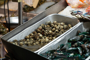 asia seafood market tray Blood cockle and green mussels, selective focus