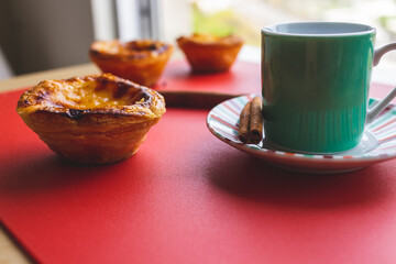 closeup of typical Portuguese dessert pastry Pastéis de Nata and cup of coffee