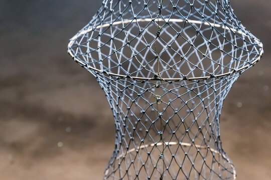 wicker fish trap network, storage tank catch close-up vertical