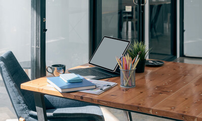 Creative workspace with tablet and keyboard, home office concept.