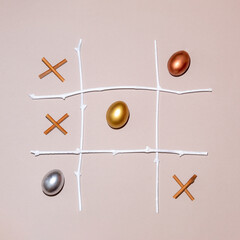 2021 Easter eggs are a winning combination. X O game made of golden, silver and bronze eggs and...