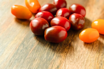 red and yellow tomato on a wooden background closeup selective focus