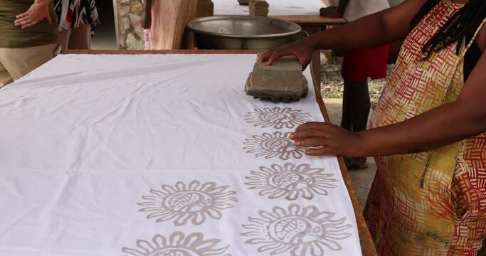 Batik fabric wax stamp material for dye Accra Ghana. Local neighborhood fabric clothing manufacturing and craft center. Ghanaian family makes, teaches and instructs in the traditional.
