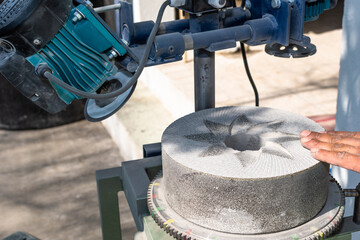stones used to grind corn being rectified with a special machine for this