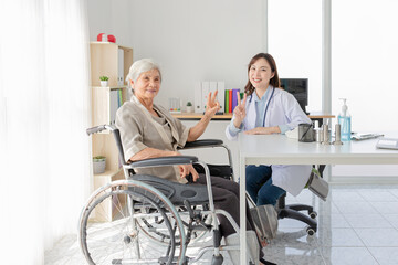 Fototapeta premium asian female doctor and old patient show v sign with hands in hospital, they talk about healthcare promotion and disease screening, elderly health check up