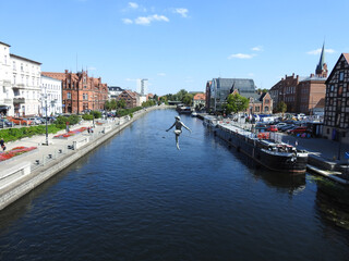 Hanging sculpture by the river in the city