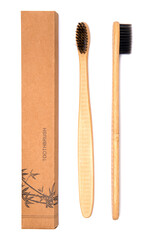 two bamboo toothbrushes in front and side view with a packing box. environmentally friendly biodegradable toothbrush isolated on white background.