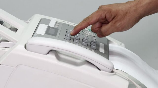 hand man are using a fax machine in the office, equipment for data transmission