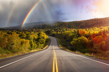 Naklejka na ściany i meble Scenic highway during a vibrant sunny day in the fall season. Dramatic Sunrise Sky with Rainbow Art Render. Taken in Newfoundland, Canada.