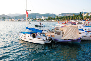 Obraz premium Beautiful View of Bodrum Beach, Aegean sea, yacht and town at sunset.