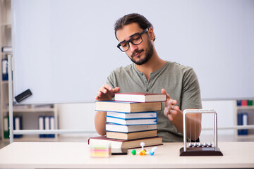 Young male student preparing for exams in the classroom