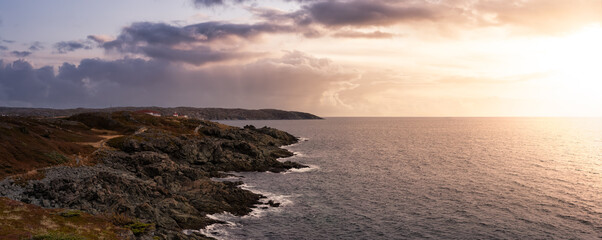 Viewpoint on the Rocky Atlantic Ocean Coast. Colorful Sunrise Sky Art Render. Taken in Saint Anthony, Newfoundland, Canada.
