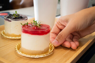 Hand holding a piece of chesse cake