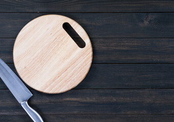 Close up kitchen knife and wooden round cutting board