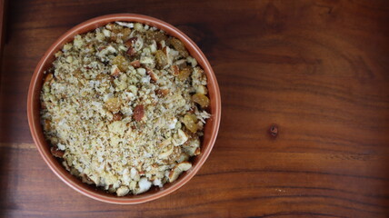 Homemade Gujiyas or sweet dumpling in a different background at home. Gujiyas are sweet dumplings made of maida or flour and filled with a delightful khoya and dry fruits mixture .
