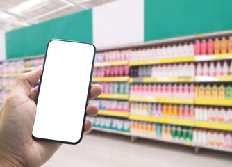 Close up hand holding smartphone and abstract bokeh and blur shopping mall and retail store interior for background