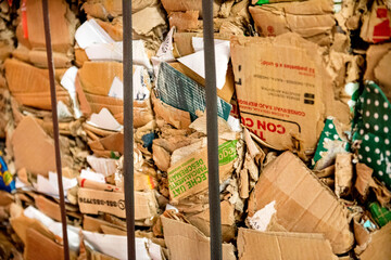 Recycle cardboard packaging concept with stacks of compressed corrugated paper garbage as a symbol to recycle for conservation and environmental technology business.