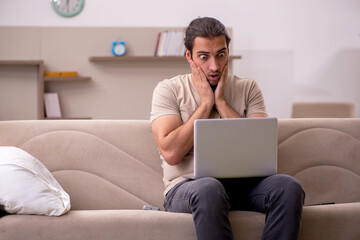 Young male freelancer working at home