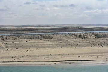 Landscape of Suez Canal, view from transiting cargo ship.