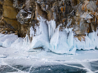 Rock Covered with Ice and Icicles at Baikal Lake in Russia in Winter. Aerial View