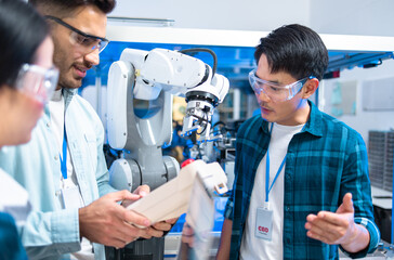 Caucasian and asian Engineers Maintenance Robot Arm at Lab. they are in a High Tech Research Laboratory with Modern Equipment. Professional Japanese Development Engineer .