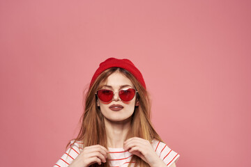 Beautiful fashionable woman in red hat with sunglasses Studio