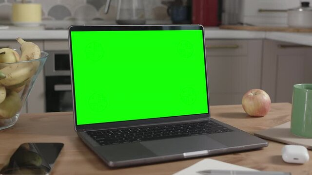 Laptop on Wooden Table in Kitchen Interior