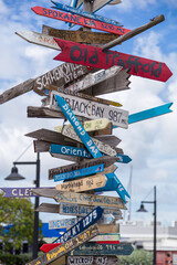 MIleage and Directional Signs Post on Key West, FL Island with Blue and Red Signs