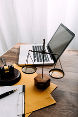 Business and lawyers discussing contract papers with brass scale on desk in office. Law, legal services, advice, justice and law concept picture with film grain effect