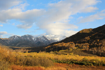 Trekking around volcanoes of Kamchatka in fall season. Northern pristine nature.